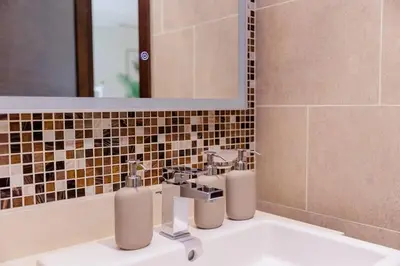 a bathroom with a sink and a mirror at Spacious Minimalistic Studio in Dubai
