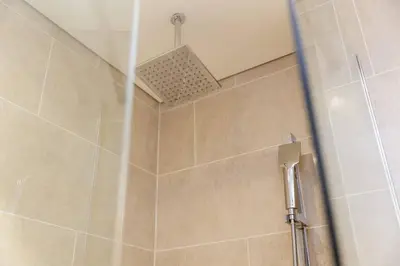 a bathroom with a shower with a shower head at Spacious Minimalistic Studio in Dubai
