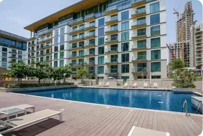 a large apartment building with a large swimming pool at Spacious Minimalistic Studio in Dubai