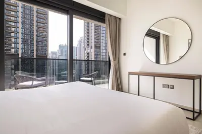 a bedroom with a large white bed and a mirror at HomesGetaway -Lavish 1BR in ACT One Downtown Dubai in Dubai