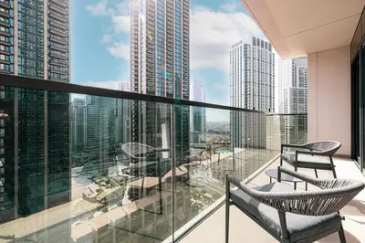 a balcony with chairs and a view of a city at HomesGetaway -Lavish 1BR in ACT One Downtown Dubai in Dubai