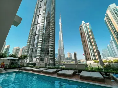 a swimming pool in the middle of a city with tall buildings at HomesGetaway -Lavish 1BR in ACT One Downtown Dubai in Dubai
