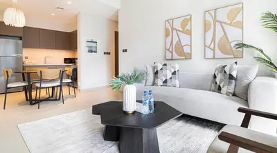 a living room with a couch and a table at HomesGetaway -Lavish 1BR in ACT One Downtown Dubai in Dubai