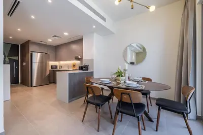 a kitchen and dining room with a table and chairs at Exclusive Spacious Villa I Garden I Maid Room in Dubai
