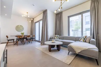 a living room with a couch and a table at Exclusive Spacious Villa I Garden I Maid Room in Dubai