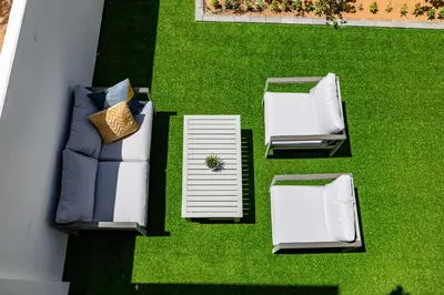 an overhead view of two chairs and a couch on grass at Exclusive Spacious Villa I Garden I Maid Room in Dubai