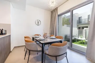 a dining room with a table and chairs at Exclusive Spacious Villa I Garden I Tilal Al Ghaf in Dubai
