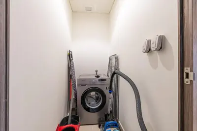 a washing machine in a corner of a room at Exclusive Spacious Villa I Garden I Tilal Al Ghaf in Dubai