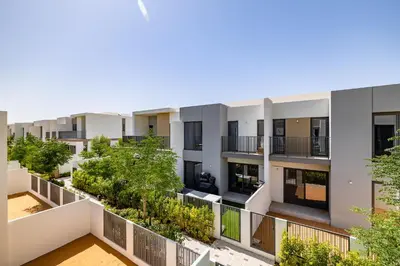 an apartment building with trees on the balcony at Exclusive Spacious Villa I Garden I Tilal Al Ghaf in Dubai
