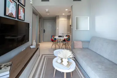 a living room with a couch and a table at Keyrock Living - Lakeview Escape in Business Bay in Dubai