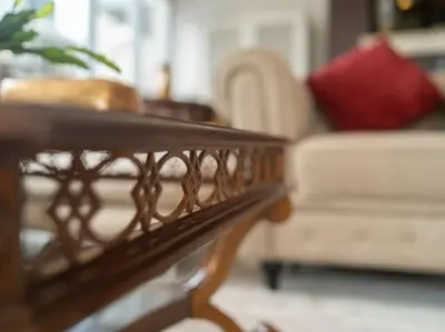 a wooden coffee table in a living room with a couch at Elegant Apartment Overlooking Dubai Mall Fountain. in Dubai