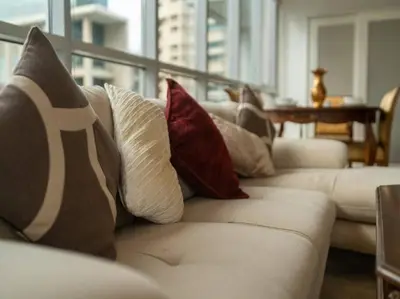 a living room with a white couch with pillows at Elegant Apartment Overlooking Dubai Mall Fountain. in Dubai
