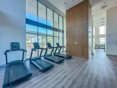 a gym with several treadmills in a building at Modern 1BR at Farhad Azizi Al Jaddaf - Sleeps 4 in Dubai