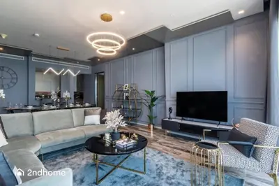 a living room with a couch and a tv at Seaside Splendor The Palm's Breathtaking View in Dubai