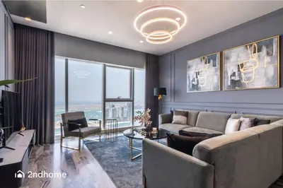 a living room with a couch and a table at Seaside Splendor The Palm's Breathtaking View in Dubai