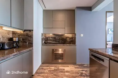 a kitchen with stainless steel appliances and marble counter tops at Seaside Splendor The Palm's Breathtaking View in Dubai
