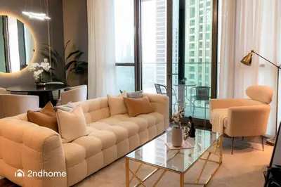 a living room with a couch and a glass table at Luxurious 1 Bed with Direct Access to Dubai Mall in Dubai