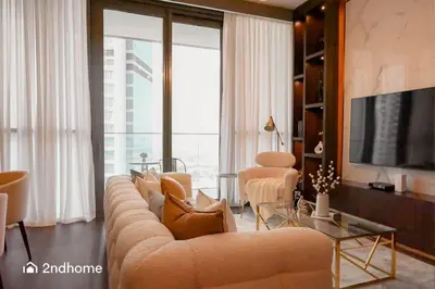 a living room with a large couch and a television at Luxurious 1 Bed with Direct Access to Dubai Mall in Dubai
