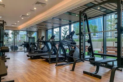 a gym with treadmills and ellipticals in a building at Frank Porter - Zada Tower in Dubai