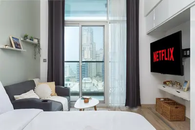 a living room with a bed and a large window at Studio With Best View Of Dubai in Dubai