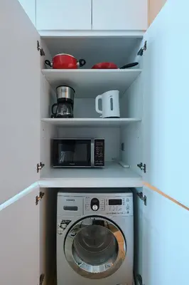 a washing machine in a kitchen with a microwave at Studio With Best View Of Dubai in Dubai