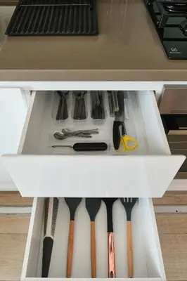 a drawer in a refrigerator filled with utensils at Studio With Best View Of Dubai in Dubai