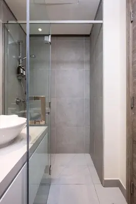 a bathroom with a glass shower and a sink at Studio With Best View Of Dubai in Dubai