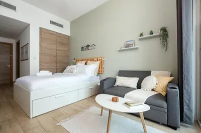 a bedroom with a bed and a couch and a table at Studio With Best View Of Dubai in Dubai