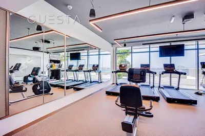 a gym with several treadmills and elliptical machines at Emaar Beachfront - Beach Vista Tower, Dubai Marina in Dubai