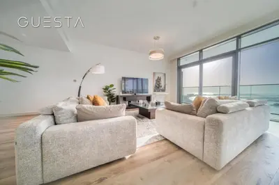 two couches in a living room with large windows at Emaar Beachfront - Beach Vista Tower, Dubai Marina in Dubai