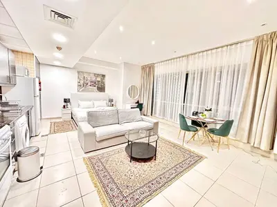 a living room with a couch and a table at Lovely Newly Furnished Ocean View Studio in Royal Oceanic Tower in Dubai