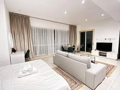 a living room with a bed and a couch at Lovely Newly Furnished Ocean View Studio in Royal Oceanic Tower in Dubai