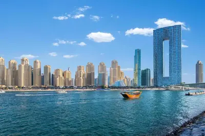 a boat in the water in front of a city at Jumeirah Beach Residence - Bahar 6, Dubai Marina in Dubai