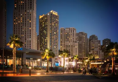 a city at night with tall buildings and palm trees at Jumeirah Beach Residence - Bahar 6, Dubai Marina in Dubai