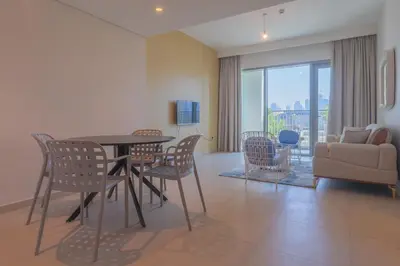 a living room with a table and chairs and a couch at BellaVista Downtown Views II T1 - 2 bedroom apartment with Burj Khalifa View in Dubai