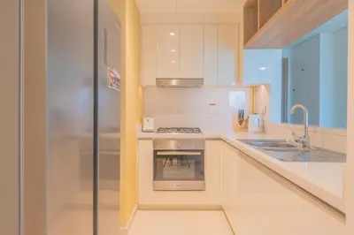 a white kitchen with a stove and a sink at BellaVista Downtown Views II T1 - 2 bedroom apartment with Burj Khalifa View in Dubai