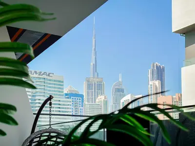 a view of a city skyline from a window at Trophy Lux Suite With Garden Balcony and Burj Khalifa Views in Dubai