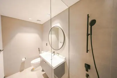 a bathroom with a toilet and a sink and a mirror at Urban Skyline City Comfort Studio in Dubai