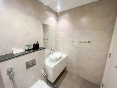 a bathroom with a sink and a toilet in it at Modern Condo With Wide City Views From Balcony in Dubai