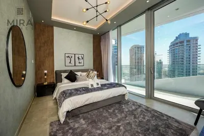 a bedroom with a large bed and a large window at Mira Holiday Homes - Stylish 1 bedroom in Dubai Marina in Dubai