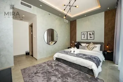 a bedroom with a large bed and a mirror at Mira Holiday Homes - Stylish 1 bedroom in Dubai Marina in Dubai