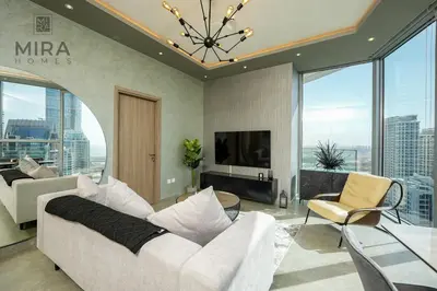 a living room with a white couch and a tv at Mira Holiday Homes - Stylish 1 bedroom in Dubai Marina in Dubai