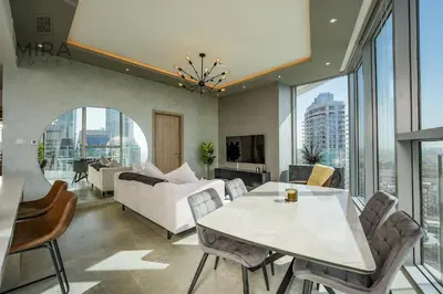 a living room with a couch and a table at Mira Holiday Homes - Stylish 1 bedroom in Dubai Marina in Dubai