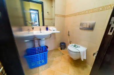 a bathroom with a sink and a toilet and a mirror at 1BR Spacious Apartment in Marina Sail By PK Holidays in Dubai