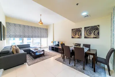 a living room with a couch and a table at 1BR Spacious Apartment in Marina Sail By PK Holidays in Dubai