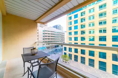 a balcony with a table and chairs and a view of a city at 1BR Spacious Apartment in Marina Sail By PK Holidays in Dubai