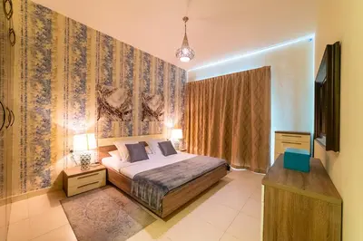a bedroom with a bed and a tv in it at 1BR Spacious Apartment in Marina Sail By PK Holidays in Dubai