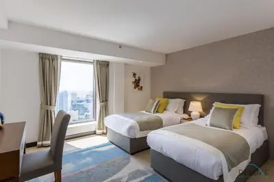 a hotel room with two beds and a window at Ain Dubai & Sea Views 2BR Close to Beach, Rimal 4, Jumeirah Beach Residence, by Deluxe Holiday Homes in Dubai