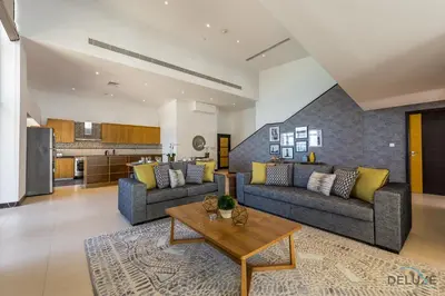 a living room with two couches and a table at Ain Dubai & Sea Views 2BR Close to Beach, Rimal 4, Jumeirah Beach Residence, by Deluxe Holiday Homes in Dubai