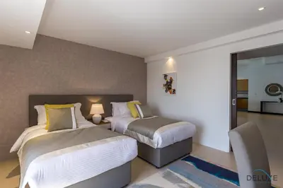 a hotel room with two beds and a mirror at Ain Dubai & Sea Views 2BR Close to Beach, Rimal 4, Jumeirah Beach Residence, by Deluxe Holiday Homes in Dubai